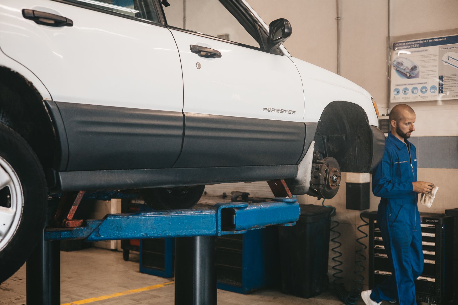 Technician evaluating vehicle Technician with subaru